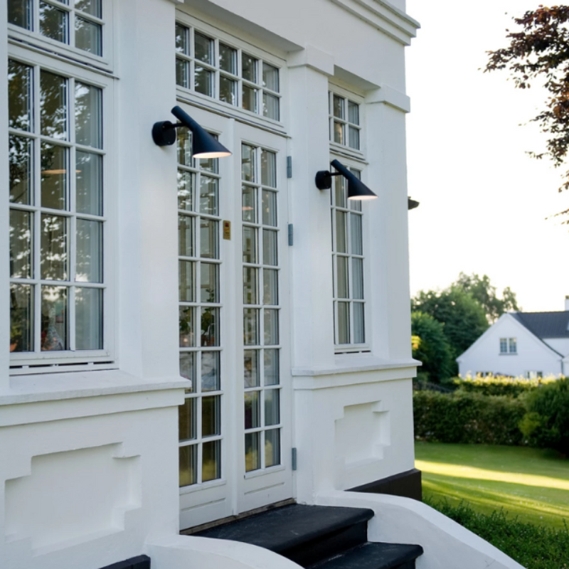 The AJ 50 Wall from Louis Poulsen outside lighting up stairs.