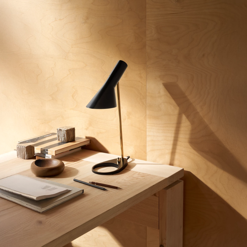 the AJ Mini Table Lamp in Brass and Black on a table.