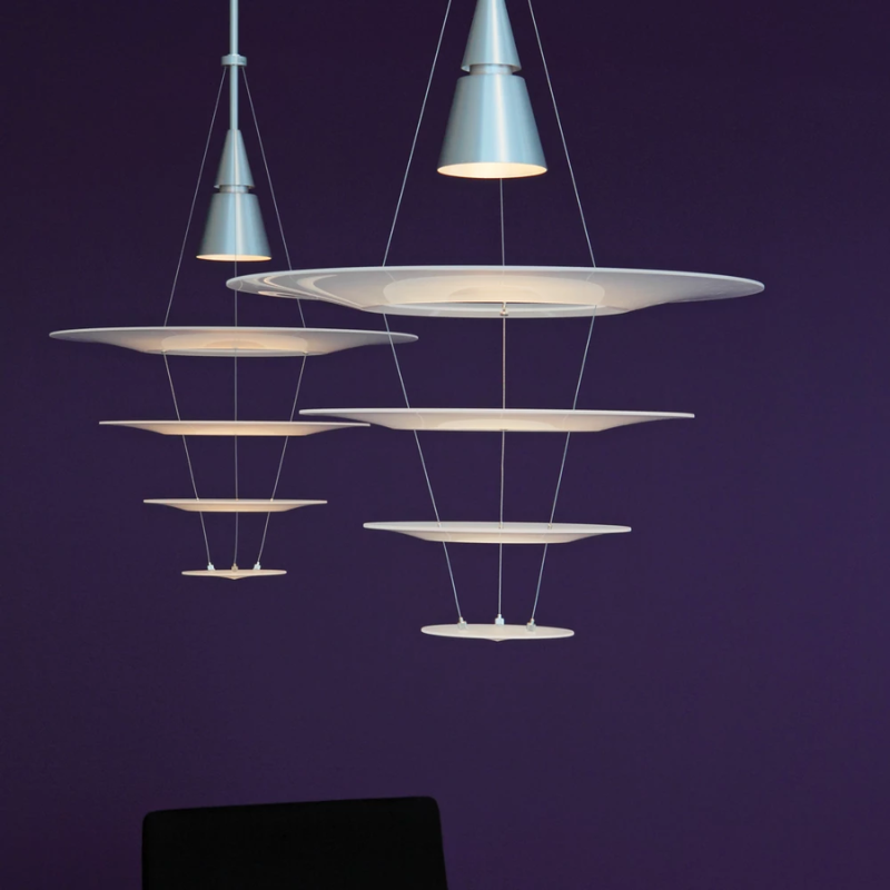 The Enigma 425 from Louis Poulsen in brushed aluminum in a living room.