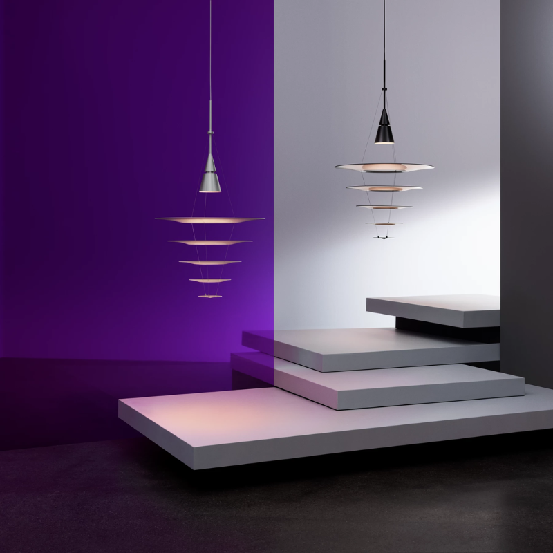 The Enigma 545 from Louis Poulsen in brushed aluminum and black in a studio. all-groups