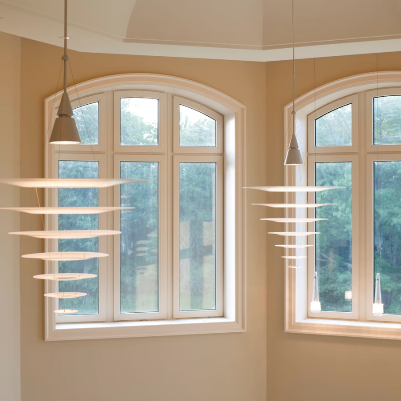 The Enigma 825 from Louis Poulsen in brushed aluminum in a dining room.