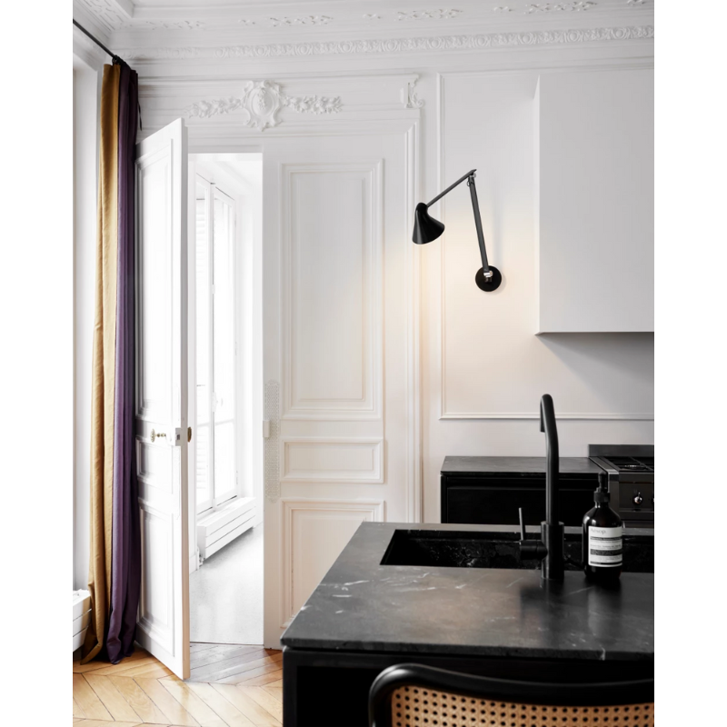 The NJP Wall from Louis Poulsen in a kitchen and dining setting.