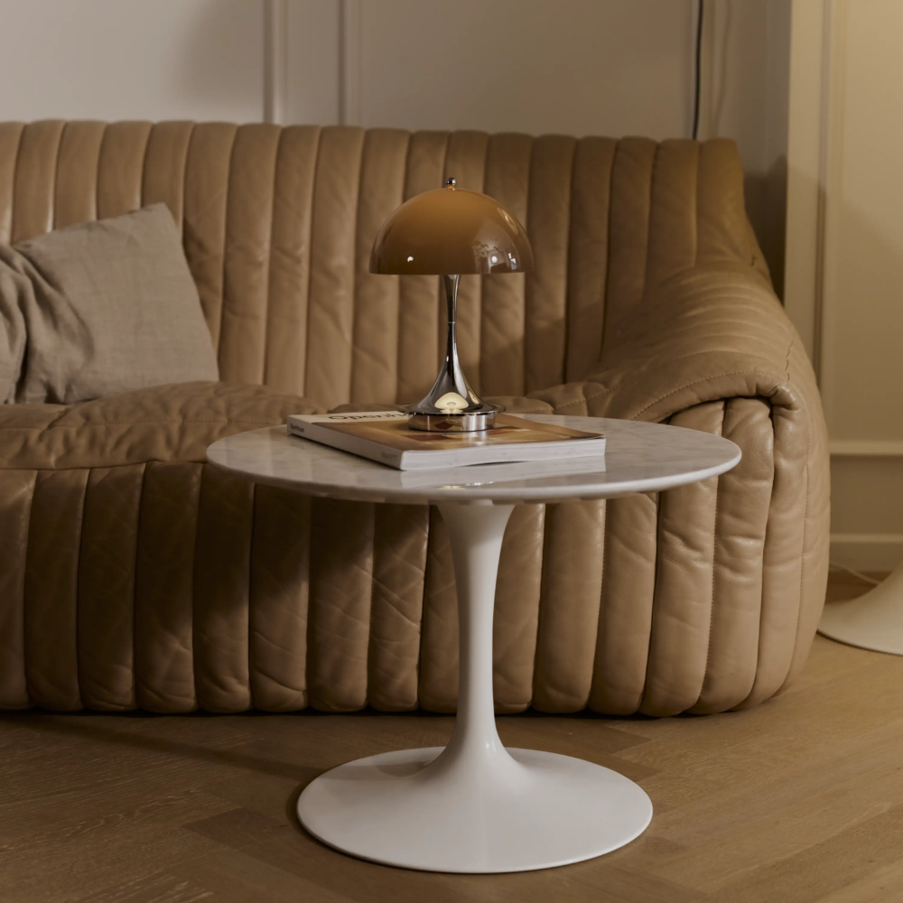 The Panthella 160 Portable Lamp from Louis Poulsen in Original Opal Brown in a living room.