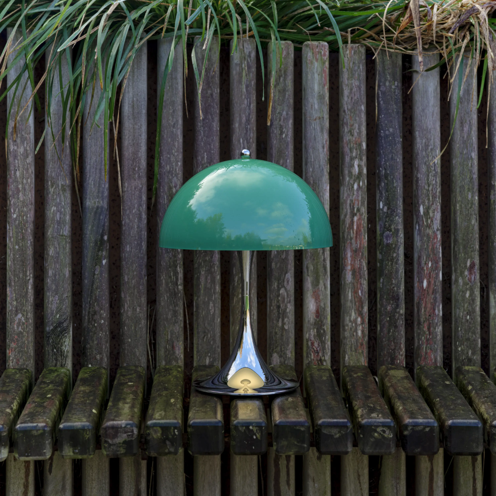 The Panthella 250 Portable Table Lamp from Louis Poulsen in Original Opal Green turned off outside.