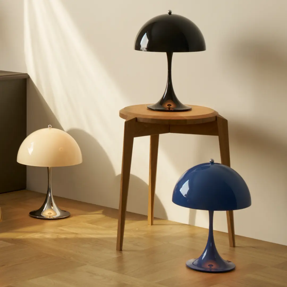 The Panthella 250 Portable Table Lamp from Louis Poulsen in Black, Original Chrome and Opal Beige, and Indigo Blue.