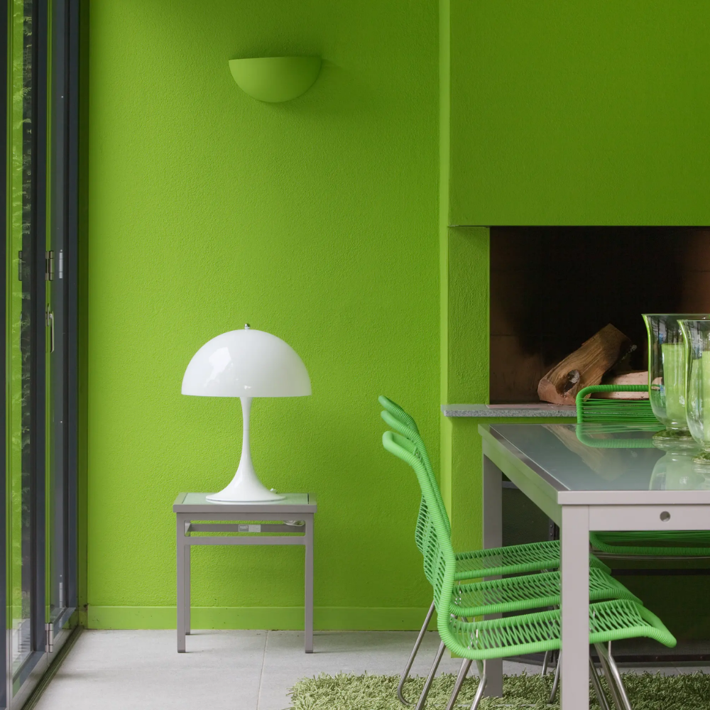The Panthella 320 Table Lamp from Louis Poulsen in a dining room.