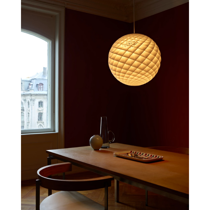 The Patera Pendant from Louis Poulsen in a family space.