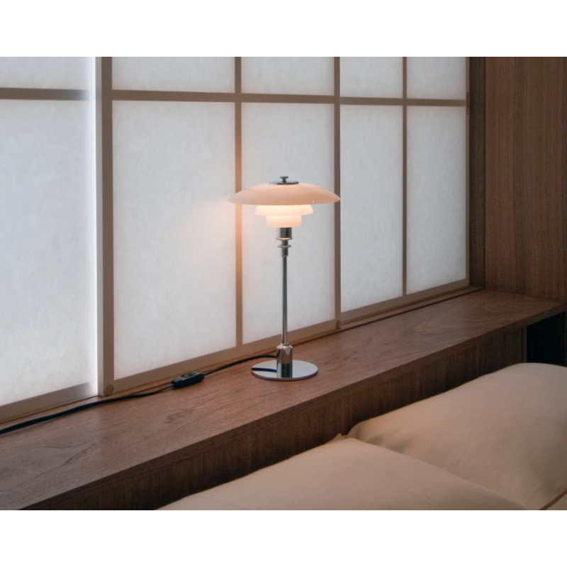 The chrome PH 2/1 Table Lamp from Louis Poulsen in a home office.