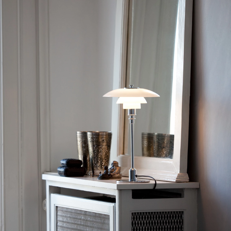The chrome PH 2/1 Table Lamp from Louis Poulsen in a primary bedroom.