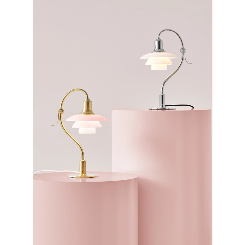 The PH 2/2 Question Mark Chrome Table Lamp from Louis Poulsen in a photograph of the Question Mark collection, alongside the Pale Rose option. all-groups