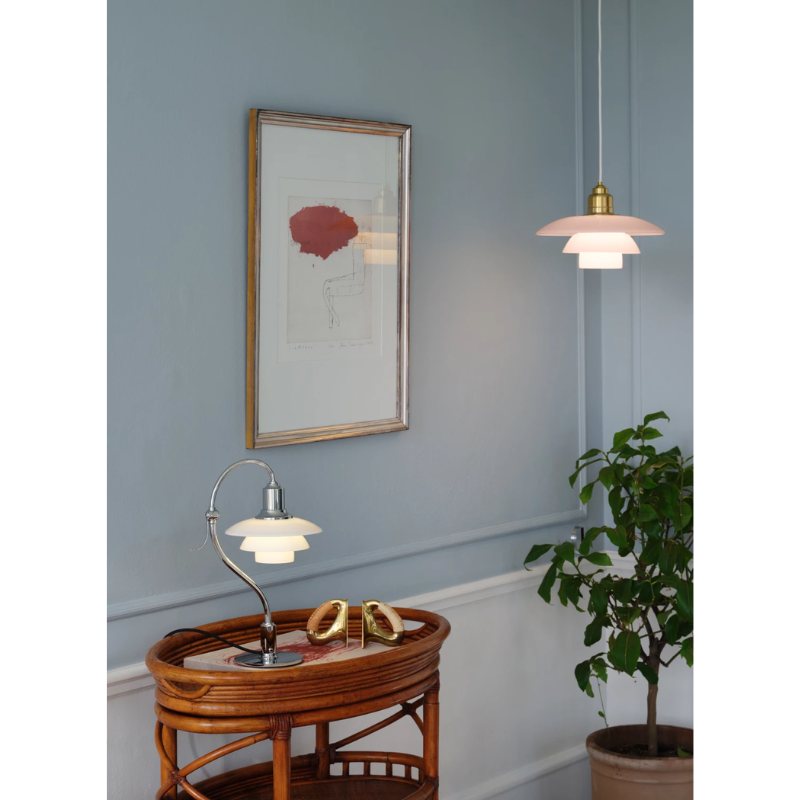 The PH 2/2 Question Mark Chrome Table Lamp from Louis Poulsen in a family area.
