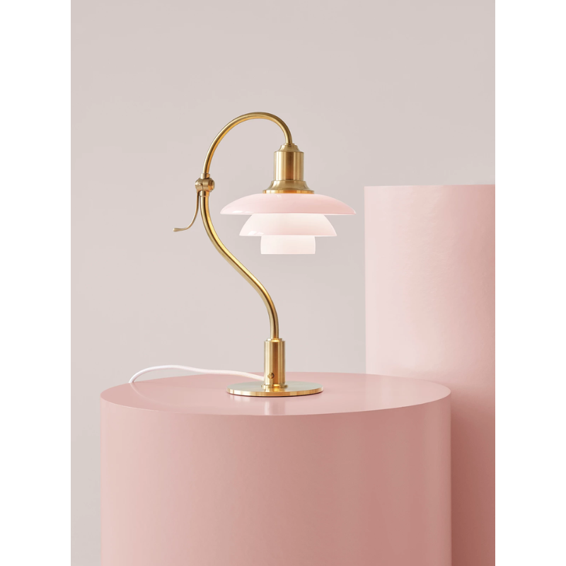 The PH 2/2 Question Mark Pale Rose Table Lamp from Louis Poulsen in an art studio.