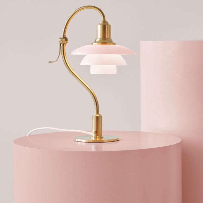 The PH 2/2 Question Mark Pale Rose Table Lamp from Louis Poulsen in an art studio.