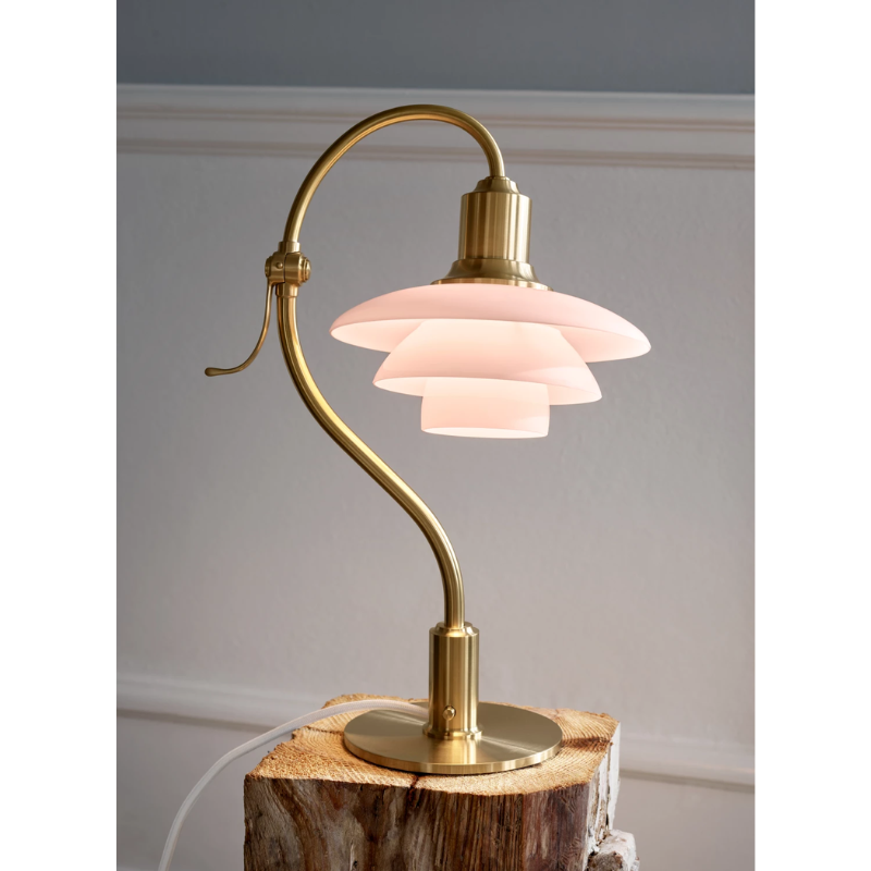The PH 2/2 Question Mark Pale Rose Table Lamp from Louis Poulsen in a home office.
