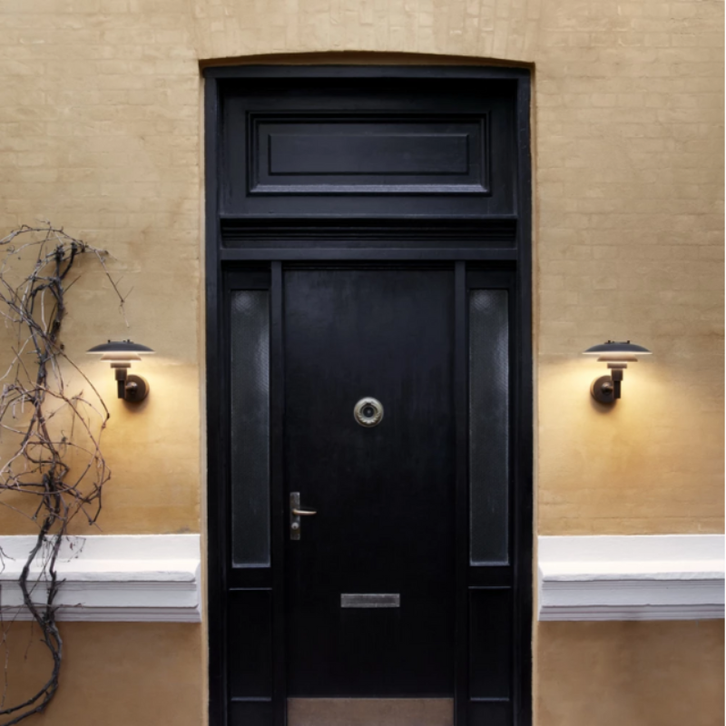 The PH 3-2½ Wall from Louis Poulsen outdoors illuminating a doorway.
