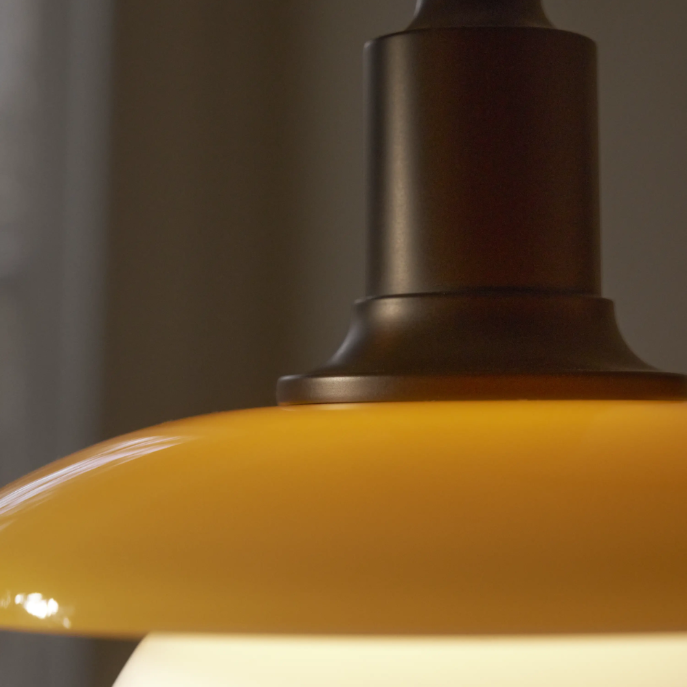 A close up of the lacquered brass suspension of the PH 3/3 Pendant Centenary Edition by Louis Poulsen.