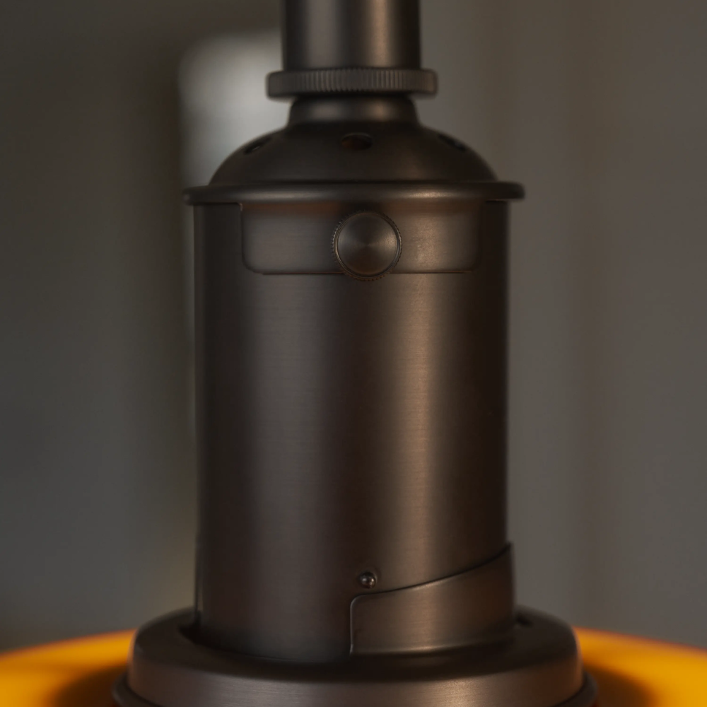 A close up of the lacquered brass suspension of the PH 3/3 Pendant Centenary Edition by Louis Poulsen.