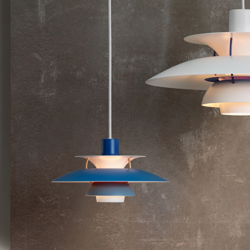 The PH 5 Mini Pendant from Louis Poulsen in hues of blue in a studio.