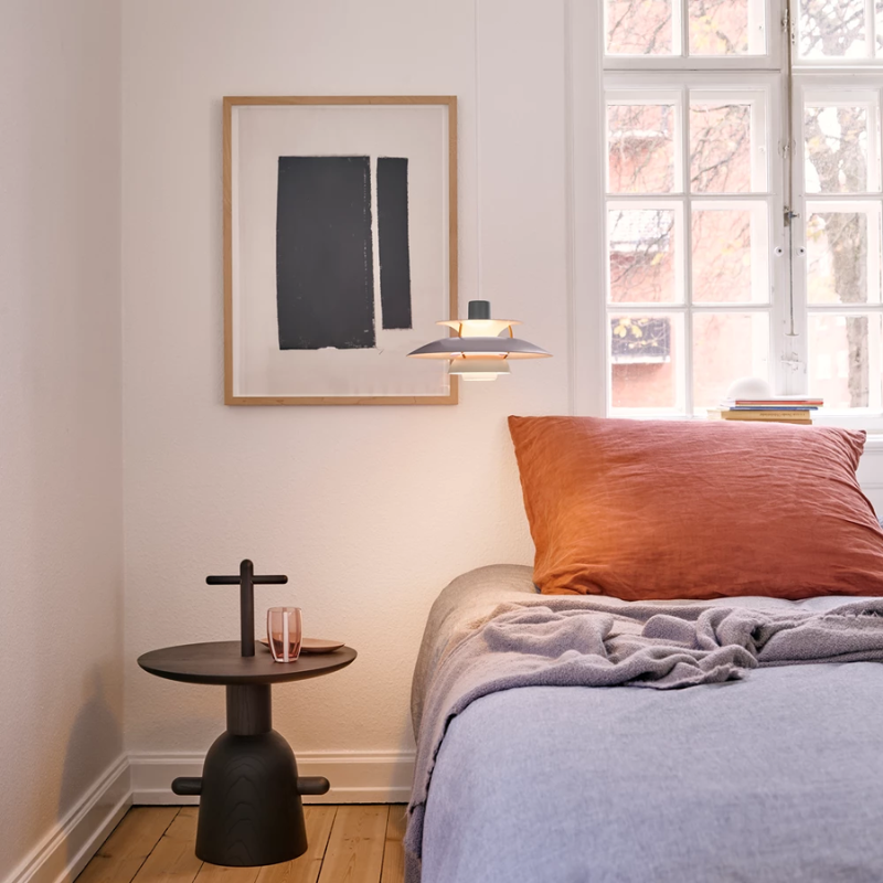 The PH 5 Mini Pendant from Louis Poulsen in hues of grey in a bedroom.