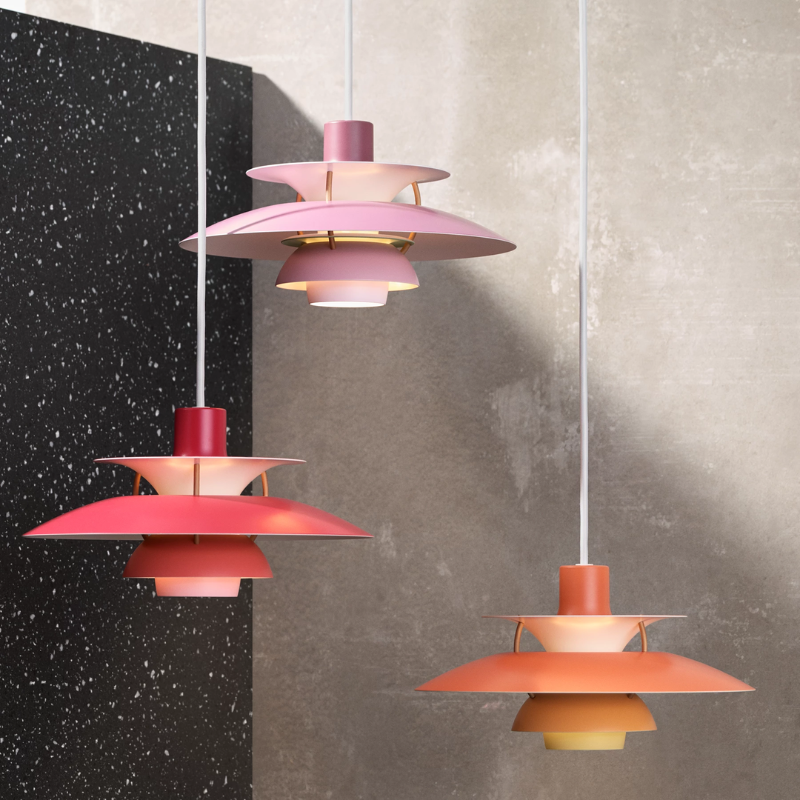 The PH 5 Mini Pendant from Louis Poulsen in hues of red in a living space.