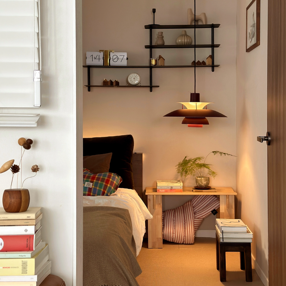 The PH 5 from Louis Poulsen in monochrome burgundy as a bedside light.