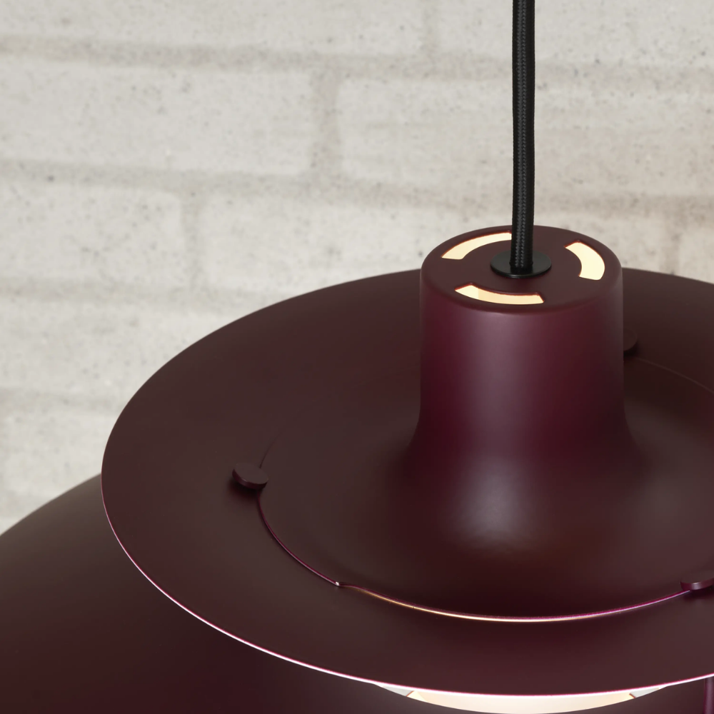 The PH 5 from Louis Poulsen in monochrome burgundy from the top.