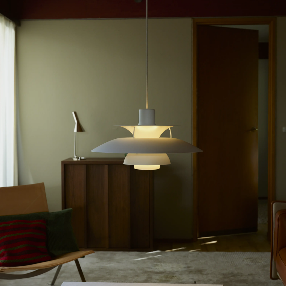 The PH 5 from Louis Poulsen in monochrome white in a living room.