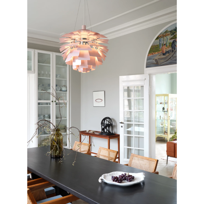 The PH Artichoke Pale Rose from Louis Poulsen in a dining room.