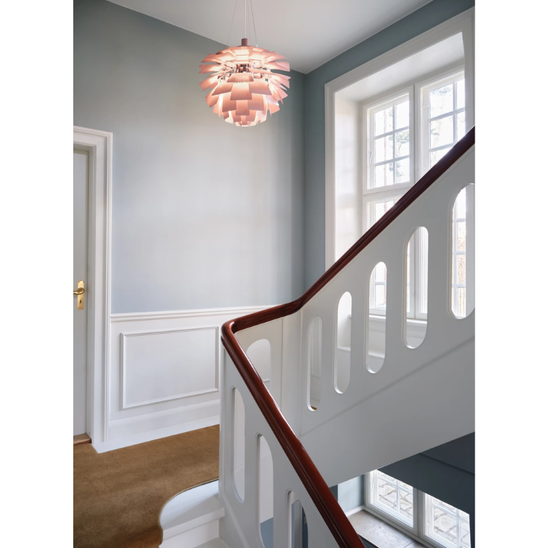 The PH Artichoke Pale Rose from Louis Poulsen in a living room.