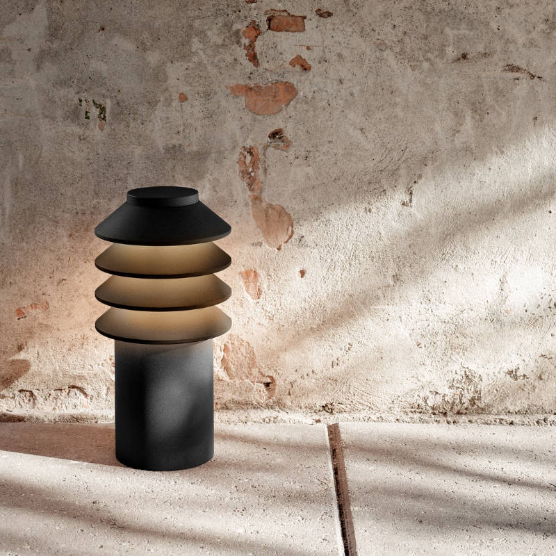 The Short Bysted Garden Bollard from Louis Poulsen in black outdoors.
