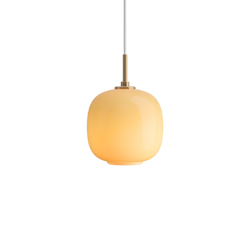 The 6.9 inch VL 45 Radiohus Pendant from Louis Poulsen with amber glass turned on.