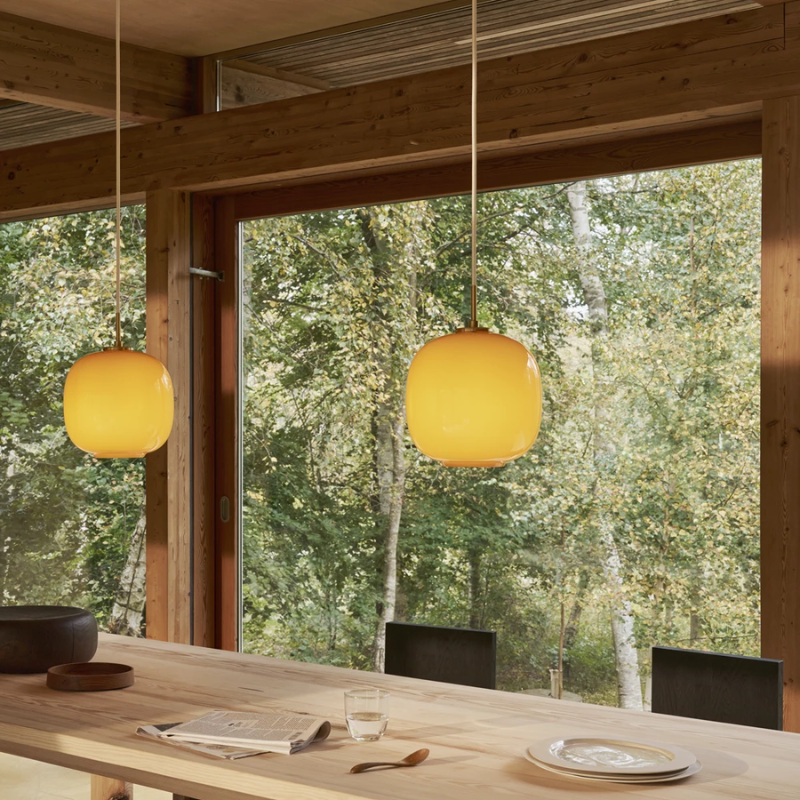 The VL 45 Radiohus Pendant from Louis Poulsen with amber glass in a designer home.