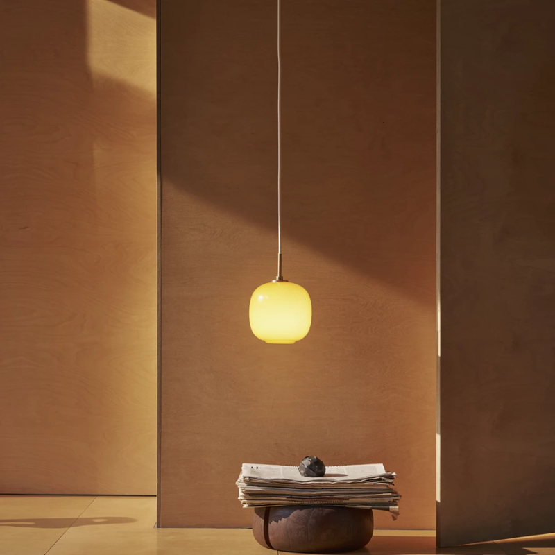 The VL 45 Radiohus Pendant from Louis Poulsen with amber glass in a gallery.