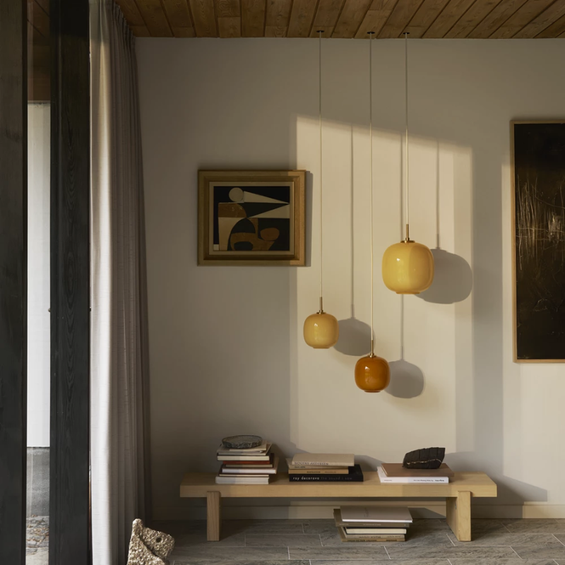The VL 45 Radiohus Pendant from Louis Poulsen in pale yellow glass in a guest room.