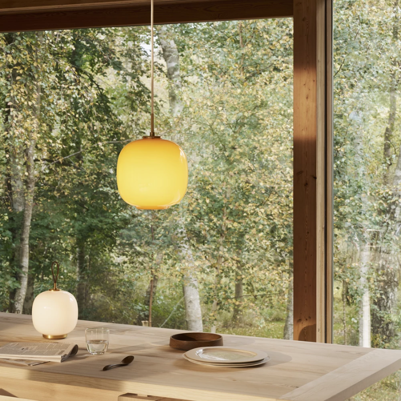 The VL 45 Radiohus Pendant from Louis Poulsen in pale yellow glass in a living room.