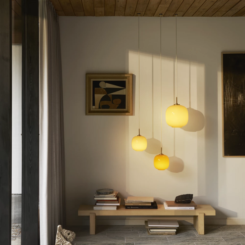 The VL 45 Radiohus Pendant from Louis Poulsen in pale yellow glass in a primary bedroom.