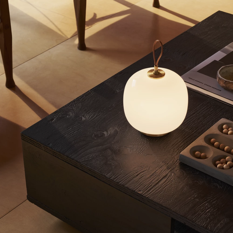 The VL 45 Radiohus Portable Lamp from Louis Poulsen in pale rose glass in a family space.