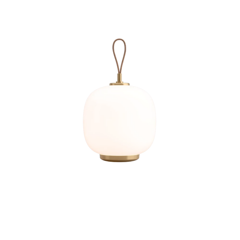 The VL 45 Radiohus Portable Lamp from Louis Poulsen in pale rose glass turned on.