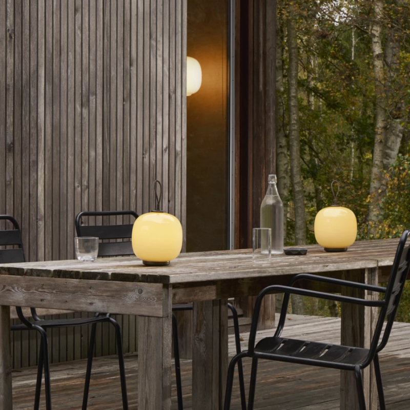 The VL 45 Radiohus Portable Lamp from Louis Poulsen in pale yellow glass in a dining room.