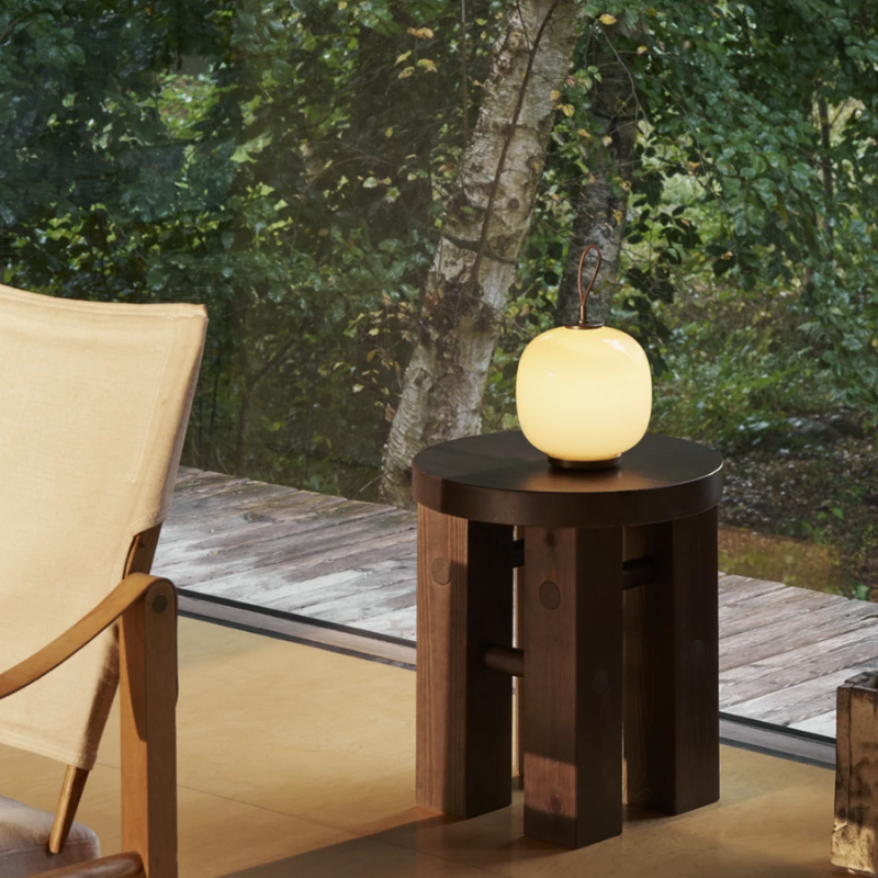 The VL 45 Radiohus Portable Lamp from Louis Poulsen in pale yellow glass in a living room.