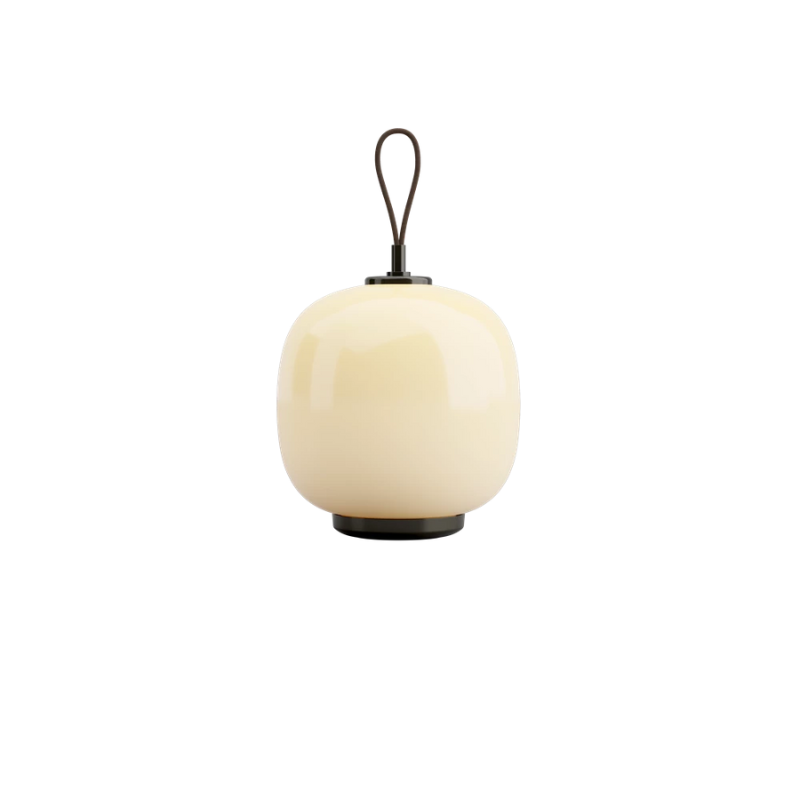 The VL 45 Radiohus Portable Lamp from Louis Poulsen in pale yellow glass turned on.