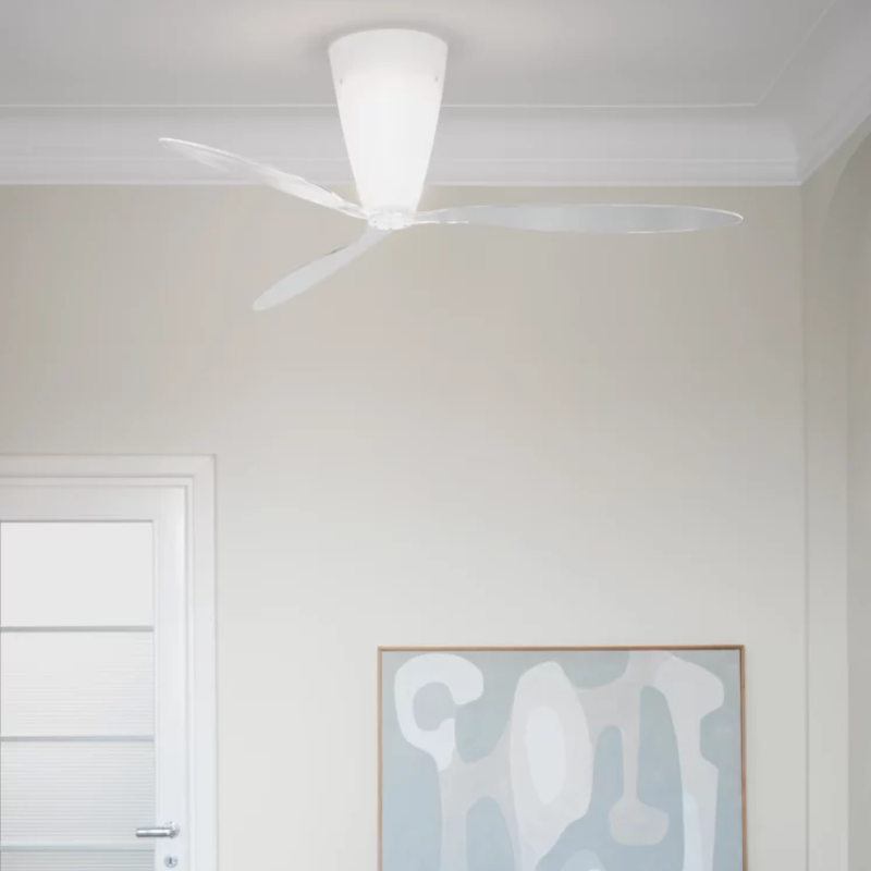 The Blow Ceiling Fan from Luceplan with transparent blades in a living room.