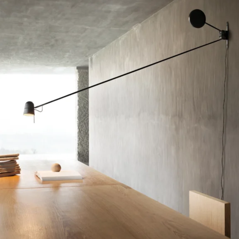 The Counterbalance Wall Sconce from Luceplan in a dining room.