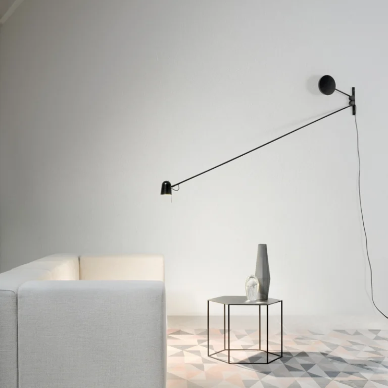 The Counterbalance Wall Sconce from Luceplan in a living room.
