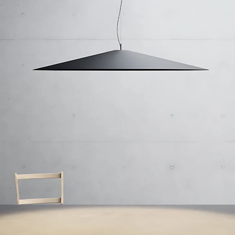 The Koinè Pendant from Luceplan in black in a dining room.