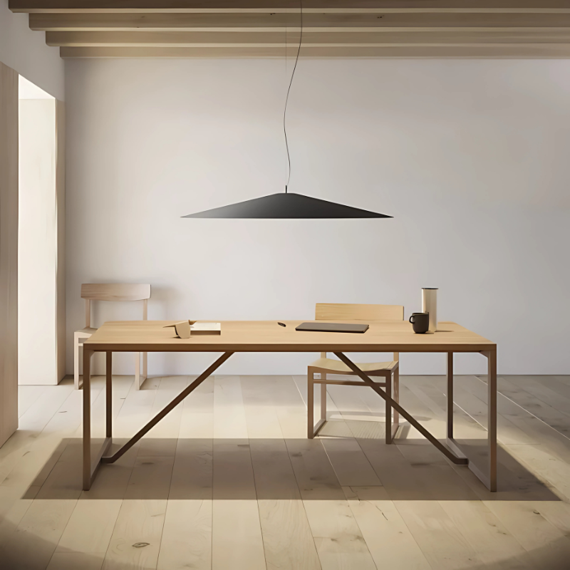 The Koinè Pendant from Luceplan in black in a home office.