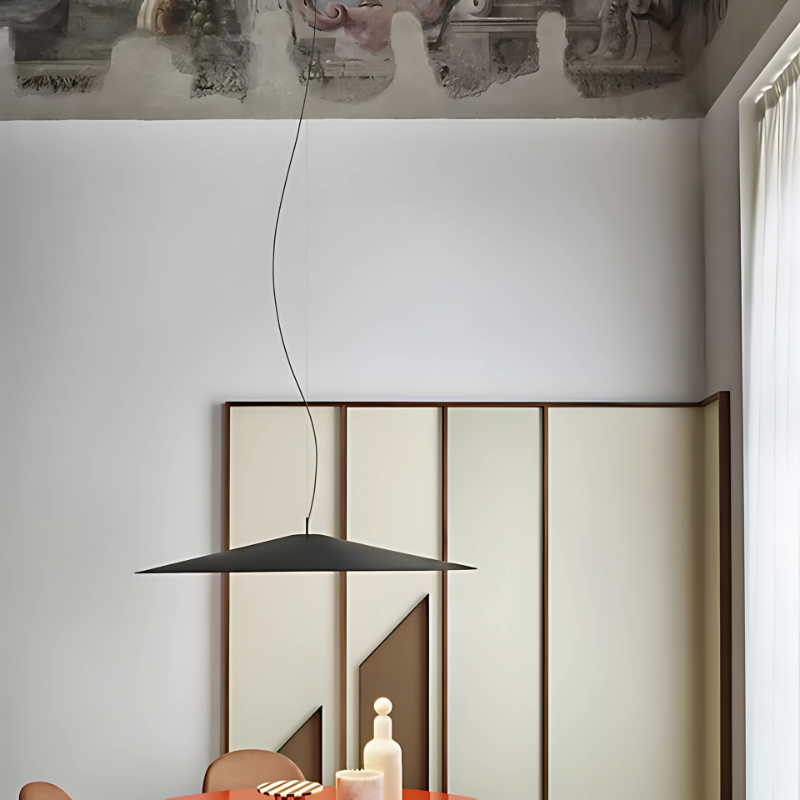 The Koinè Pendant from Luceplan in black in a living room.