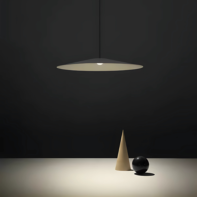 The Koinè Pendant from Luceplan in black in a studio.