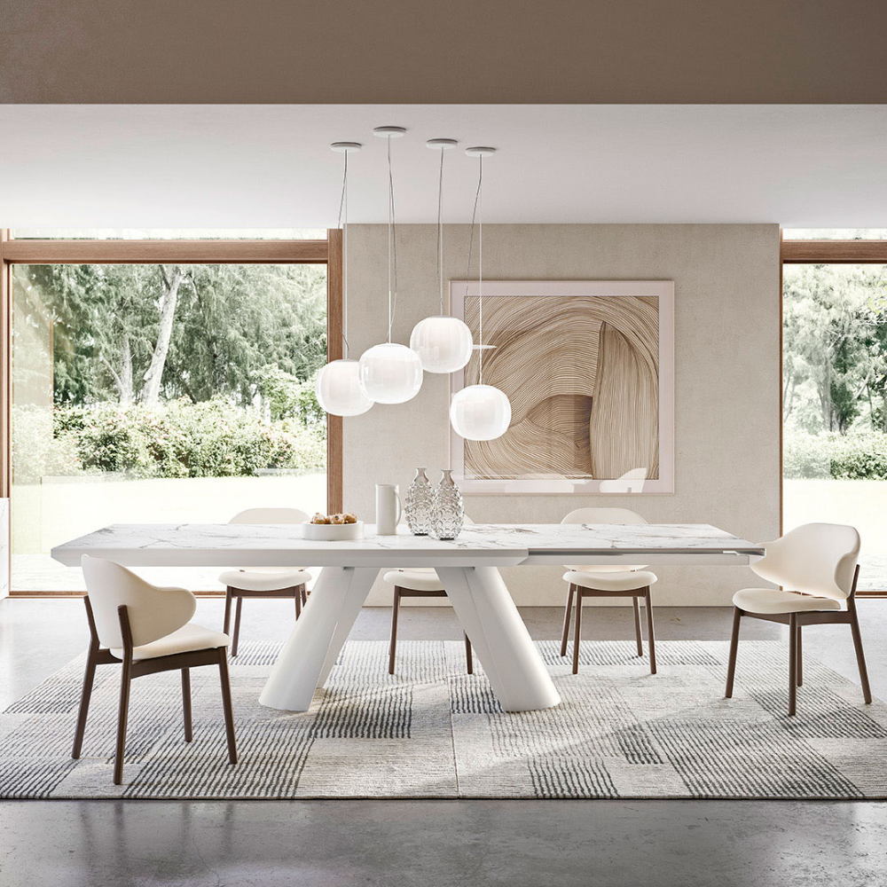 The Lita Pendant by Luceplan, 11.8-inch pendants in matte white over dining room table.