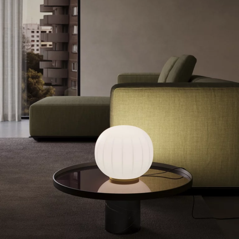 The large 12 inch Lita Table Lamp from Luceplan in a lounge.